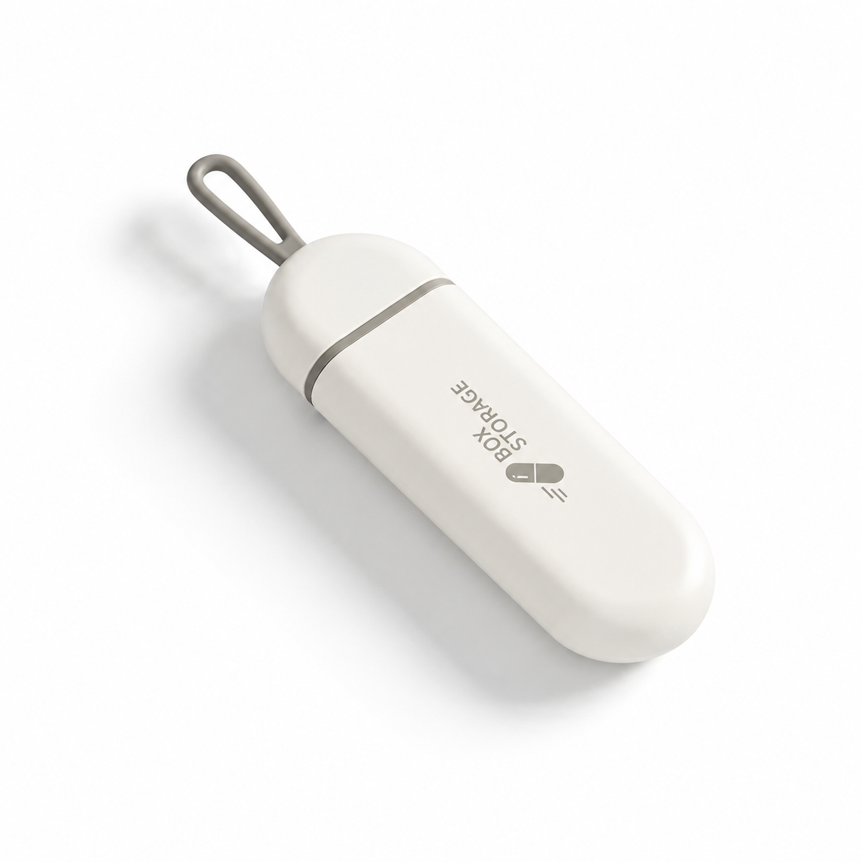 UNTIOR white and grey pull-out pill case in closed view with compact capsule shape, hanging loop, and BPA-free daily storage design.
