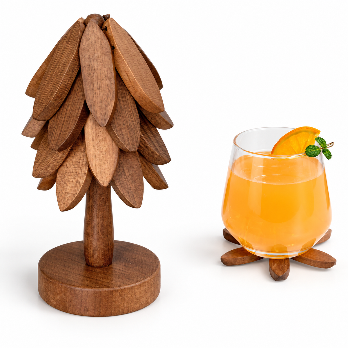 UNTIOR wooden tree-shaped coaster set with layered leaf-shaped wooden coasters, round display stand and a glass of orange drink on a coaster.